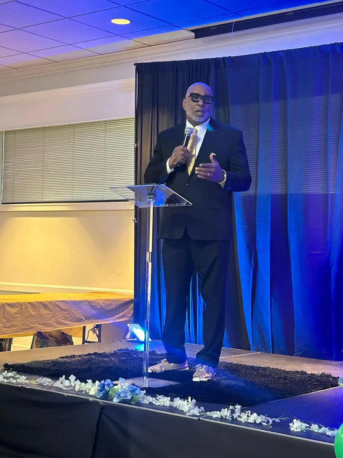 A speaker addresses guests at the 1st Annual Sneaker Ball Fundraiser
